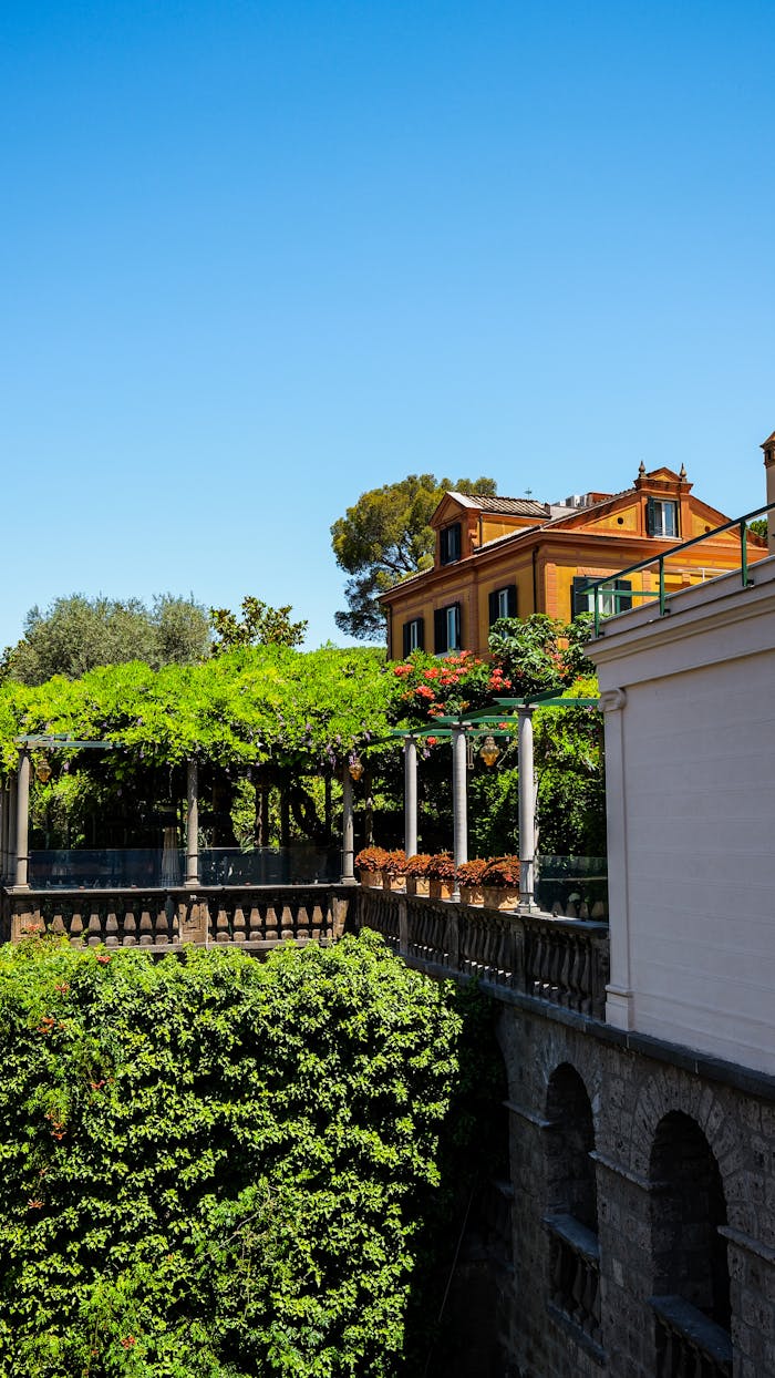 A bright Italian villa with a beautiful garden terrace on a sunny day.