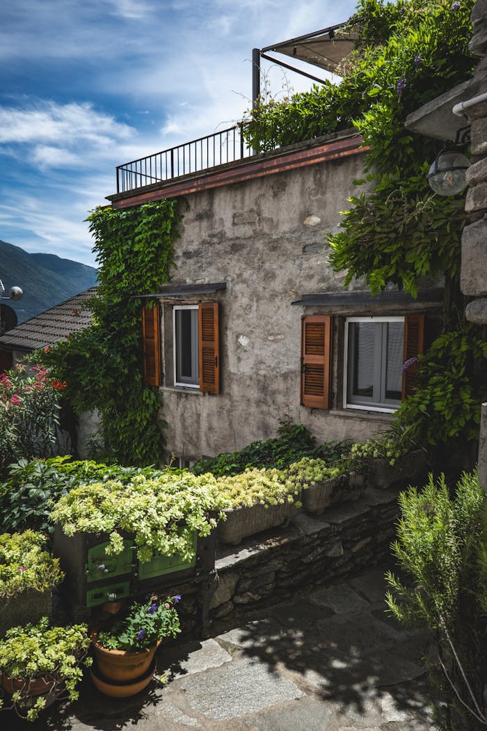Crafting Captivating Headlines: Your awesome post title goes here Rustic villa in Pianello del Lario with lush greenery and stone architecture.
